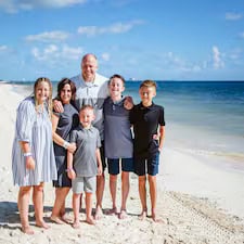 Family posing on a sunny beach vacation.