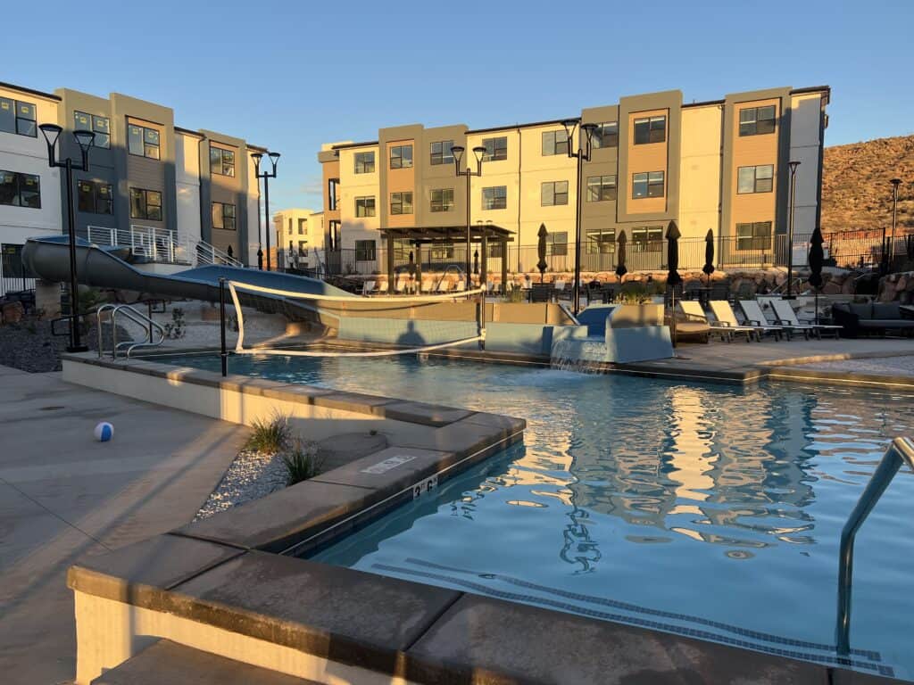 Modern apartment complex with outdoor pool and slide.