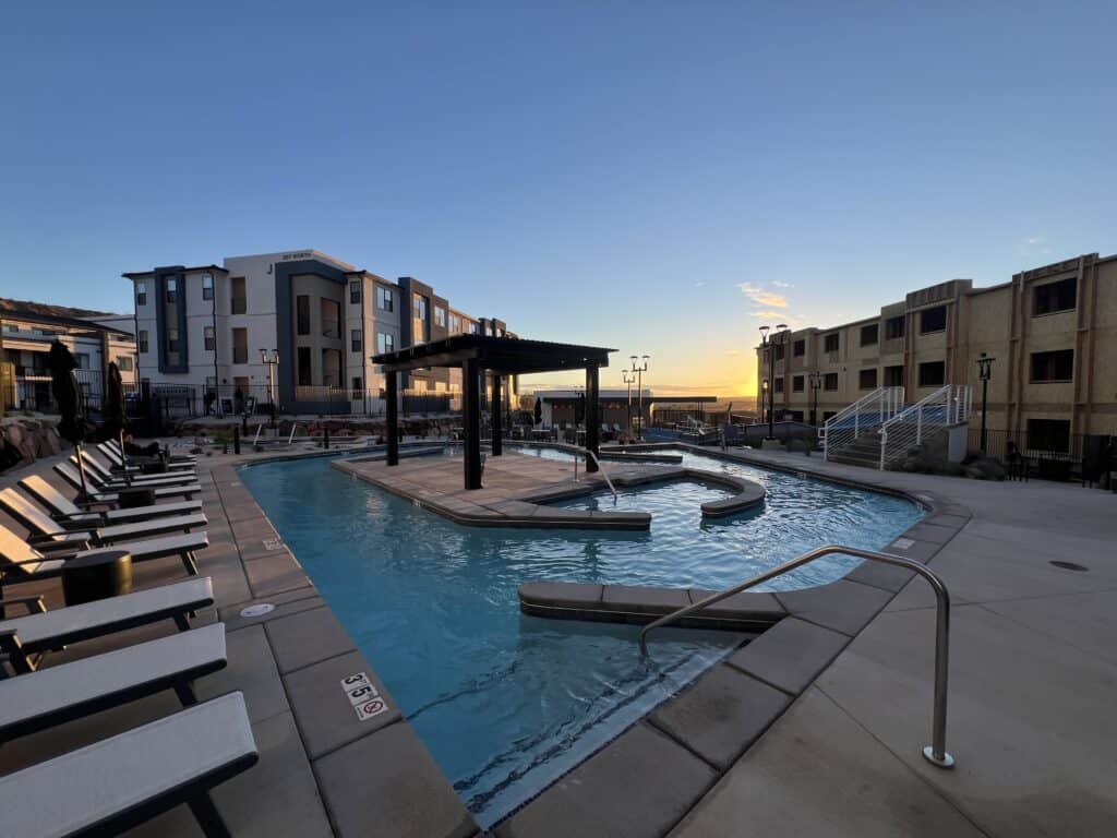 Apartment complex with outdoor pool at sunset