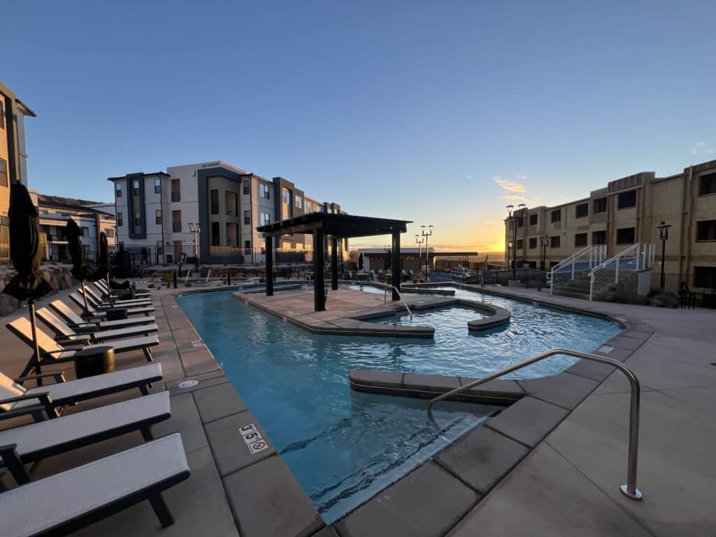 Sunset view of modern apartment pool area.