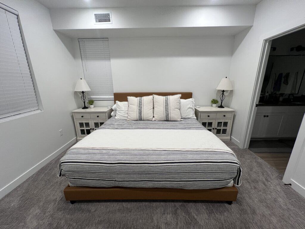 Modern bedroom with striped bedding and side tables