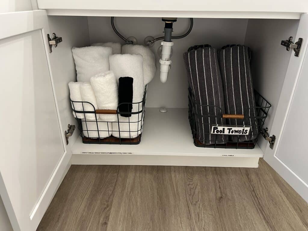 Organized towel baskets under sink cabinet