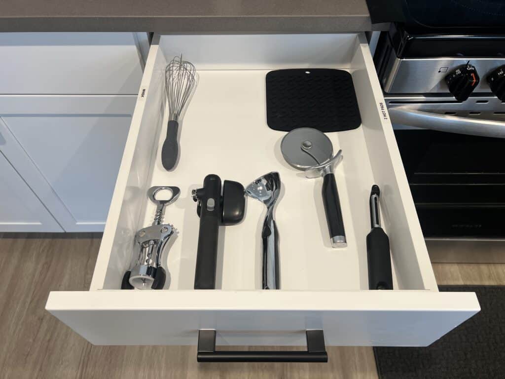 Kitchen drawer with various utensils neatly organized.