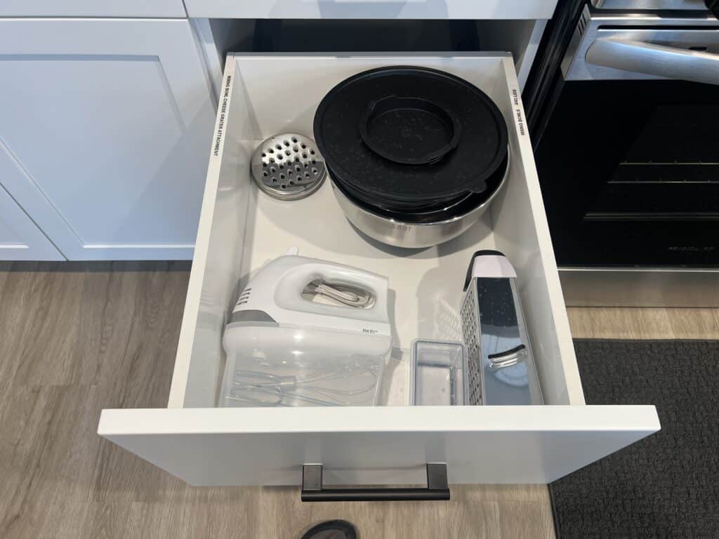 Kitchen drawer with mixer and grater.