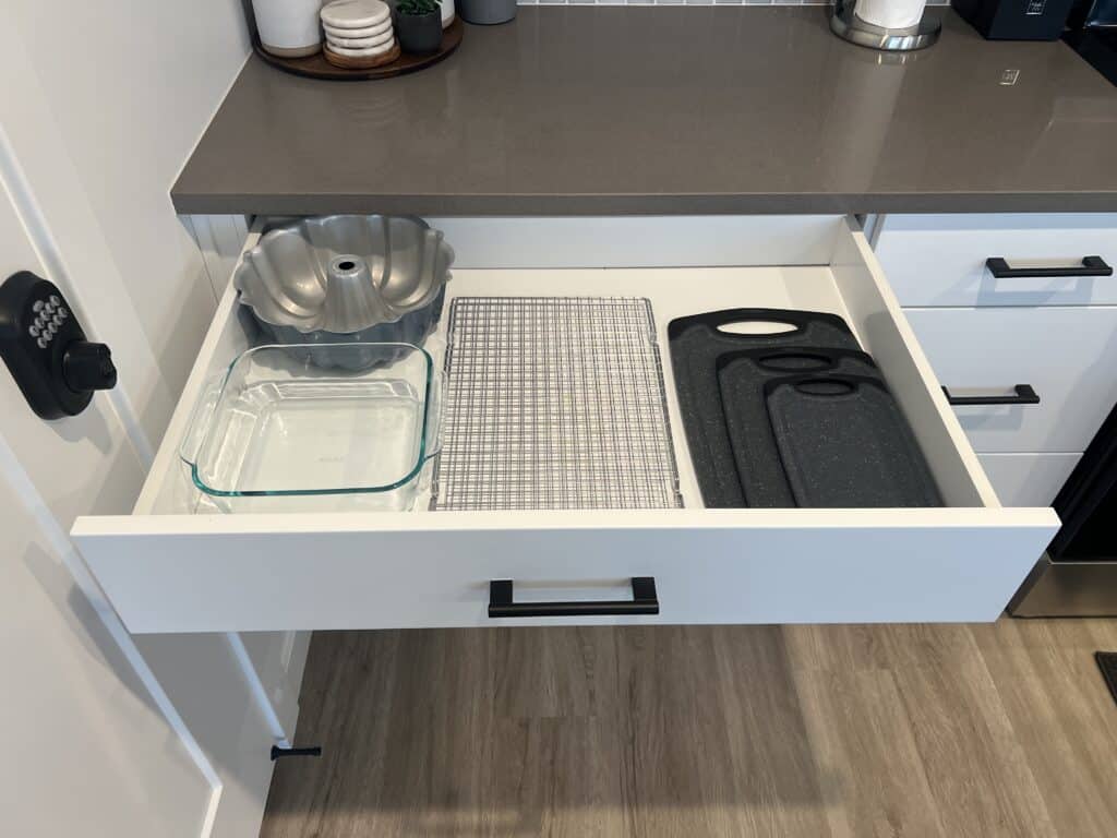 Drawer with baking pans and cutting boards.