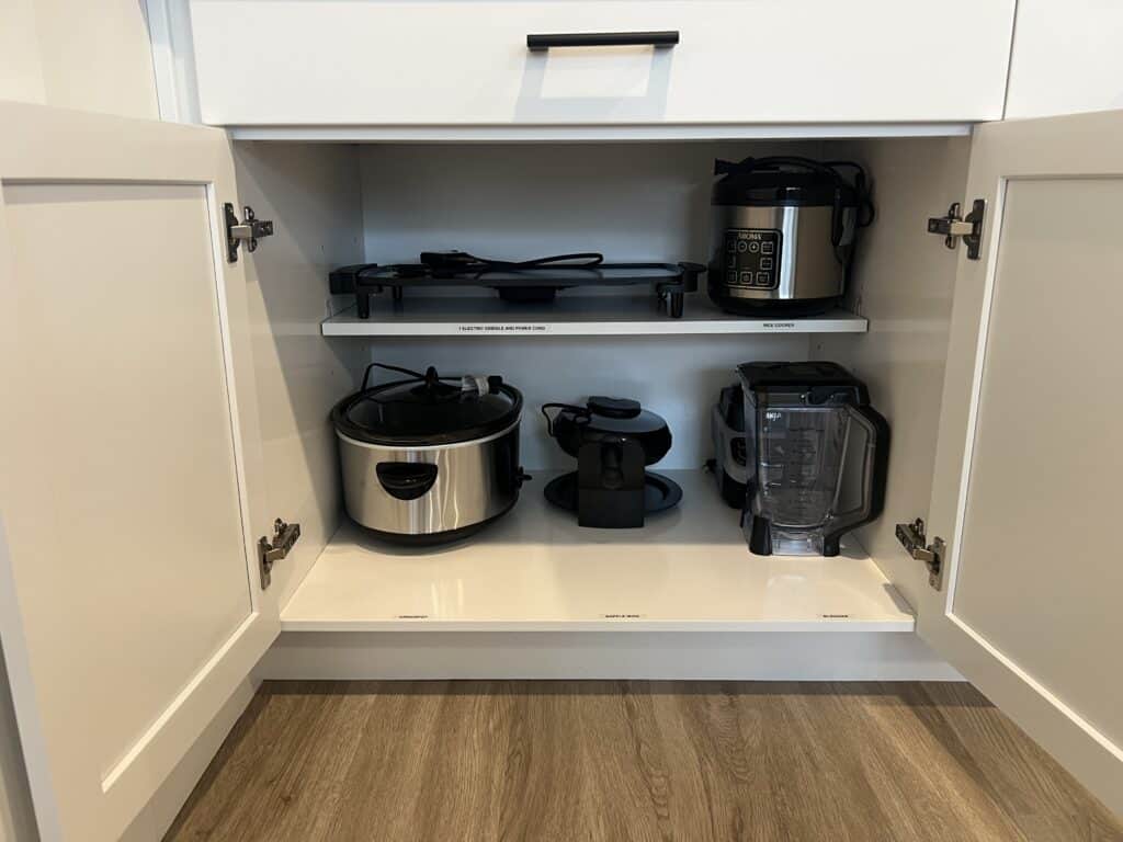 Kitchen appliances in open white cabinet