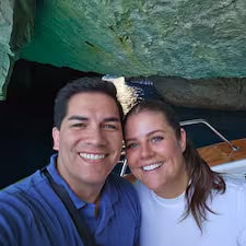 Smiling couple on a boat inside a cave.