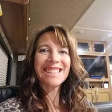 Smiling person sitting inside a cozy camper van.