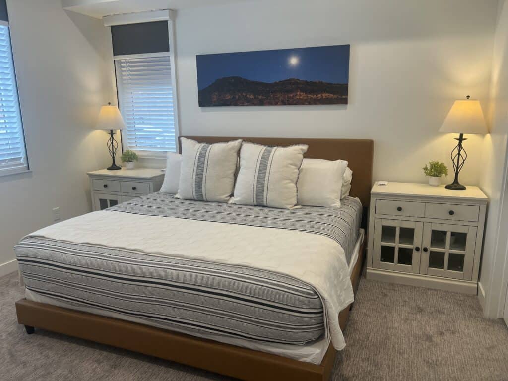 Cozy bedroom with striped bedding and nightstands
