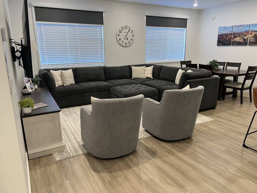 Modern living room with sectional and swivel chairs.